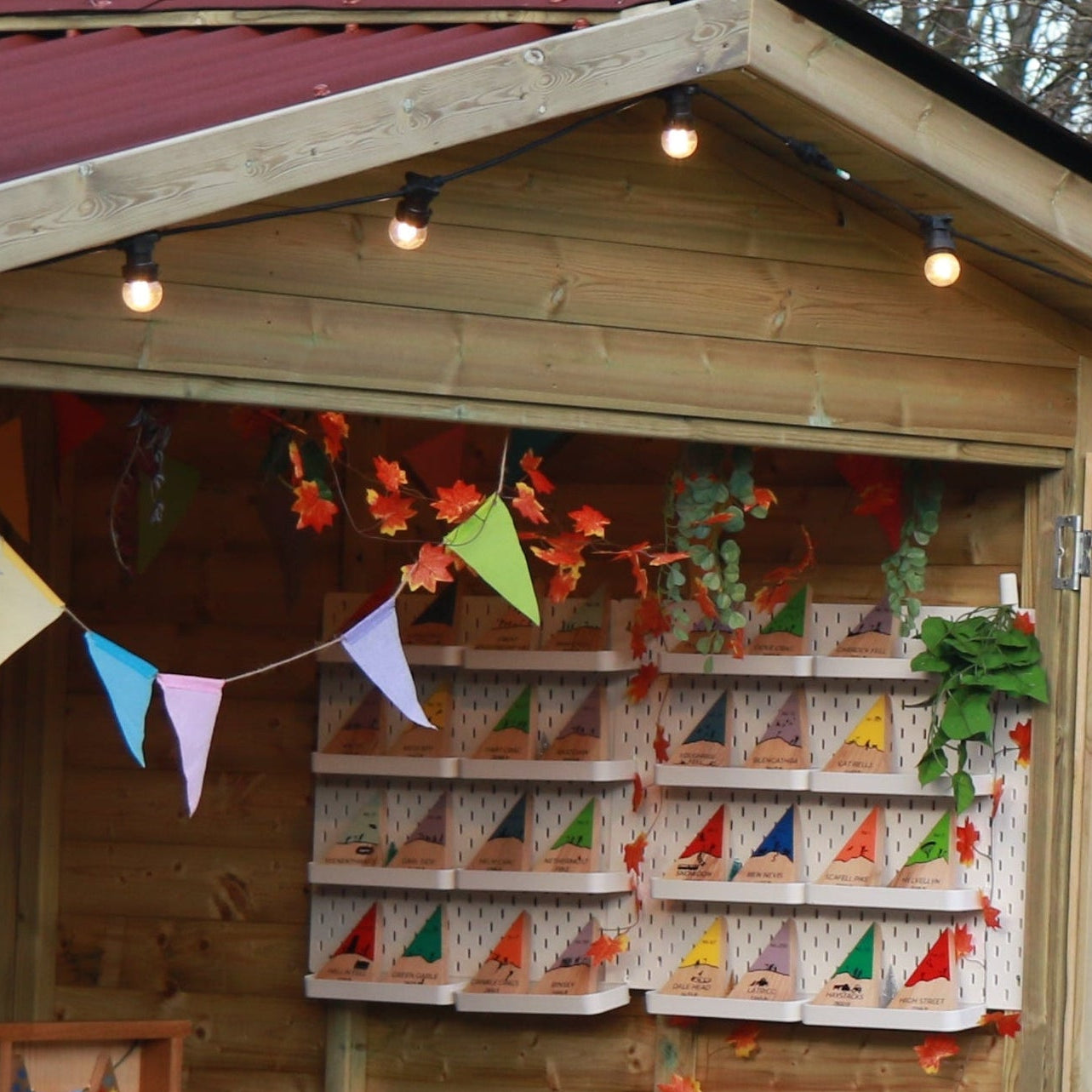 Wooden stalls with festive decorations at an outdoor market.