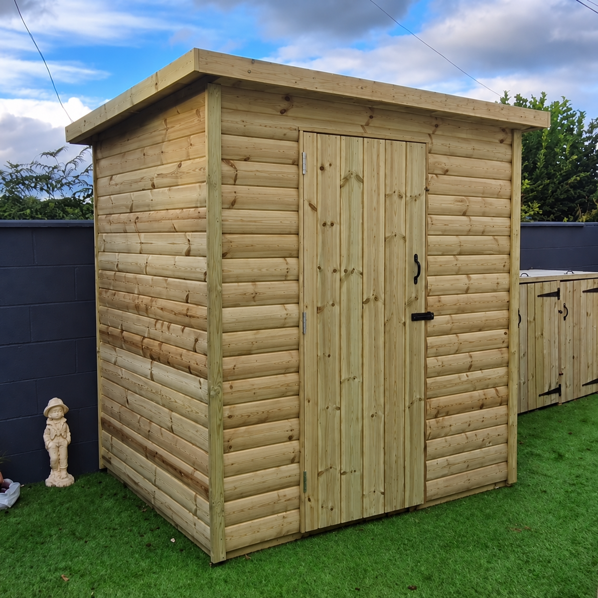 Pressure-treated pent shed with single door and windowless front