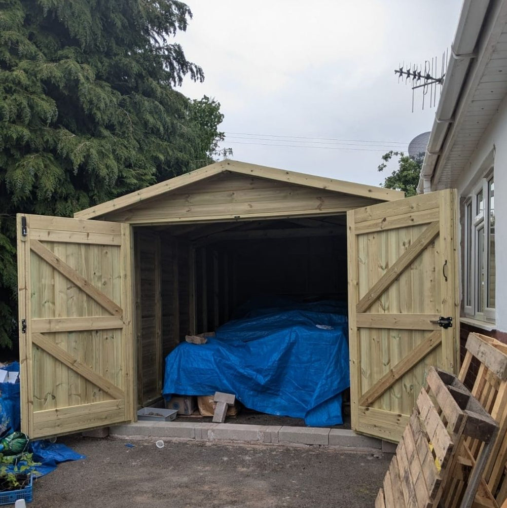 Wooden garage exterior with pressure treated loglap cladding