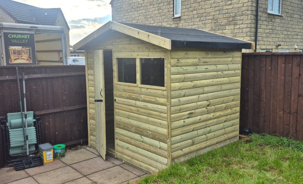 Pressure-treated apex shed with door to the left