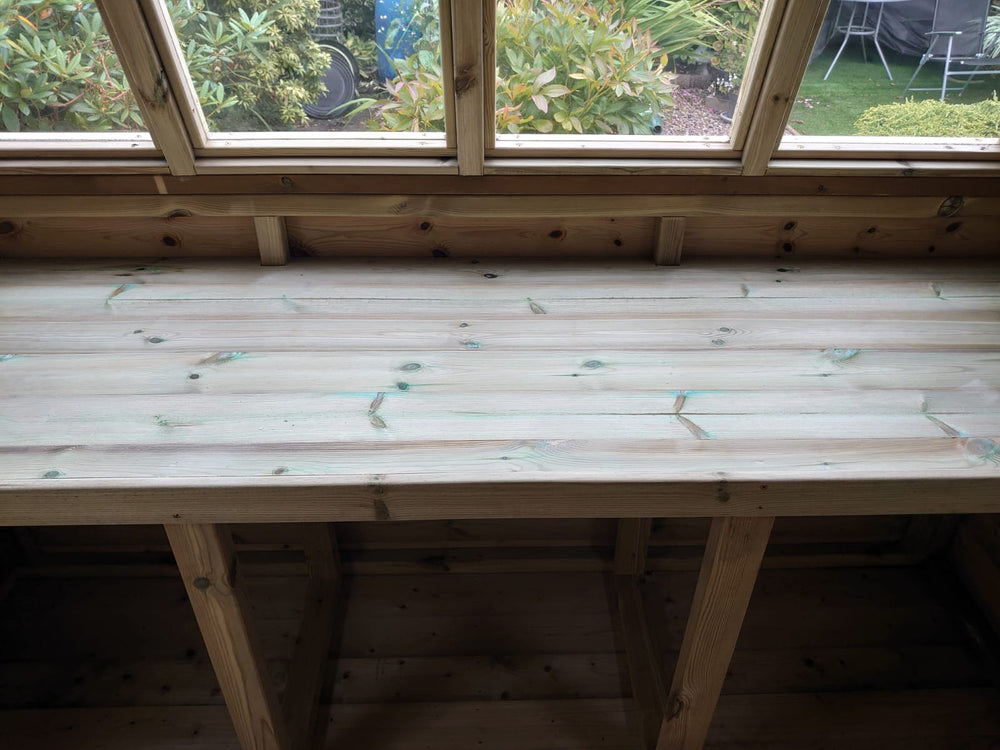 Potting shed interior bench beneath front windows