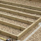 Close-up of pressure-treated timber shed base frame and joist spacing